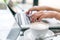 Closeup of Latte Coffee art and woman hand typing on laptop key