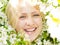 Closeup laughing woman among blossom tree