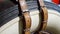 Closeup of leather belts holding spare wheel tire on old vintage car