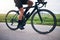 Closeup, legs and athlete on bicycle outdoor for exercise, training and triathlon sports. Person, bike and cycling on