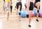 Closeup of Legs of Four Caucasian Female Athletes Having Body Stretching Exercises