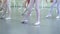 Closeup legs of little ballerinas group in white shoes practicing in ballet school slow motion