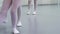 Closeup legs of little ballerinas group in white shoes practicing in classical ballet studio