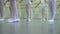 Closeup legs of little ballerinas group in white shoes practicing in classical ballet studio