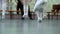 Closeup legs of little ballerinas group in white shoes practicing in classical ballet studio