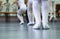 Closeup legs of little ballerinas group in white shoes practicing in classical ballet studio