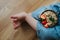 Closeup of legs little girl and a plate oatmeal with bananas and strawberries