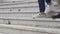 Closeup of legs walking down stairs, colleagues leaving office after workday