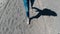 Closeup legs of woman walking in a volcanic dusty desert