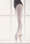 Closeup legs of young ballerina in pointe shoes, ballet practice