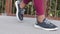 Closeup legs of young black girl in leggings and sneakers. African athletic biracial woman doing sports walking