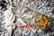 Closeup of letter, bottle and marine knot lying on pebbles