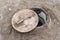 Closeup of a lid partially covering a hole in which Cozido das Furnas is cooked on the island of SÃ£o Miguel in the Azores