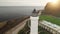 Closeup lighthouse at sun island aerial. Nobody nature seascape. White isolated buildings on valley