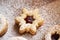Closeup of a Linzer Christmas cookie filled with marmalade