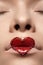Closeup lips with red heart make-up & rhinestones. Valentines Day style