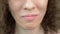 Closeup lips. woman eating a cucumber with a fork.