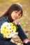 Closeup little asian girl holding flowers