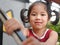 Closeup of a little baby girl, 42 months old, enjoys walking down the stairs by herself, holding on to handrail