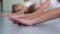 Closeup little ballerina stretching on floor practicing in ballet school slow motion