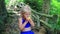 Closeup Little Blond Girl Eats Large Apple in Jungle