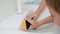 Closeup of little boy helping mother washing sink with sponge and detergent at bathroom. Concept of family teamwork and