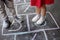 Closeup of little boy`s and girl`s legs and hopscotch drawn on asphalt. Child playing hopscotch game on playground outdoors on a