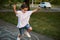 Closeup of little Caucasian girl playing hopscotch on asphalt. Child playing hopscotch game on playground outdoors on a sunny day