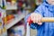 Closeup on little child hand holding on to shopping cart,blue jacket