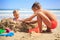 Closeup Little Girl Boy Sit in Sand Hole Play on Beach