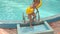 Closeup Little Girl Comes out of Pool with Ladder to Poolside