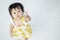 Closeup little girl look like she want something on white tiled floor textured background with copy space