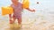 Closeup Little Girl in Safety Armbands Goes out of Sea