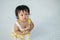 Closeup little girl with swollen eye from insect bite with red bruise on white tiled floor background