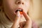 Closeup of little girl taking medicine in pill