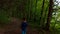 Closeup of little girl walking on a footpath, alone in dark, spooky forest