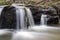 Closeup long exposure of soft cascading woodland waterfall