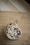 Closeup looking down of stock of freshly baked chocolate chip cookies stacked on cutting board