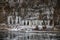 Closeup of lots of icicles, river in winter