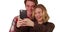 Closeup of loving couple taking selfie with smart phone in studio with copyspace