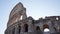 Closeup low-angle view exterior facade of ancient ruined of Roman Colosseum amphitheater on sunny day on background of