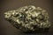 Closeup macro image of black lead zinc ore with irregular chaotic texture