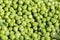 Closeup macro pile of fresh green peas ready for cleaning