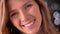 Closeup macro portrait of happy stunning caucasian female face looking straight at camera and smiling