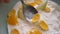 Closeup macro shoot of hand dipping a spoon in tasty yogurt breakfast bowl with fruits and cornflakes