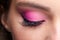 Closeup macro shot of closed human female eye. Girl with perfect skin and pink eyes shadows
