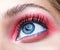 Closeup macro shot of closed human female eye with pink smoky eyes shadows