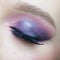 Closeup macro shot of human female eye. Woman with lilac beauty eyes makeup