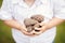 Closeup macro shot image of child with mother parent holding a bunch of pine cones