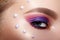 Closeup Macro of Woman Face with Purple and Pink Eye Make-up. Fashion Celebrate Makeup, Perls Decor, Perfect Shape Brows